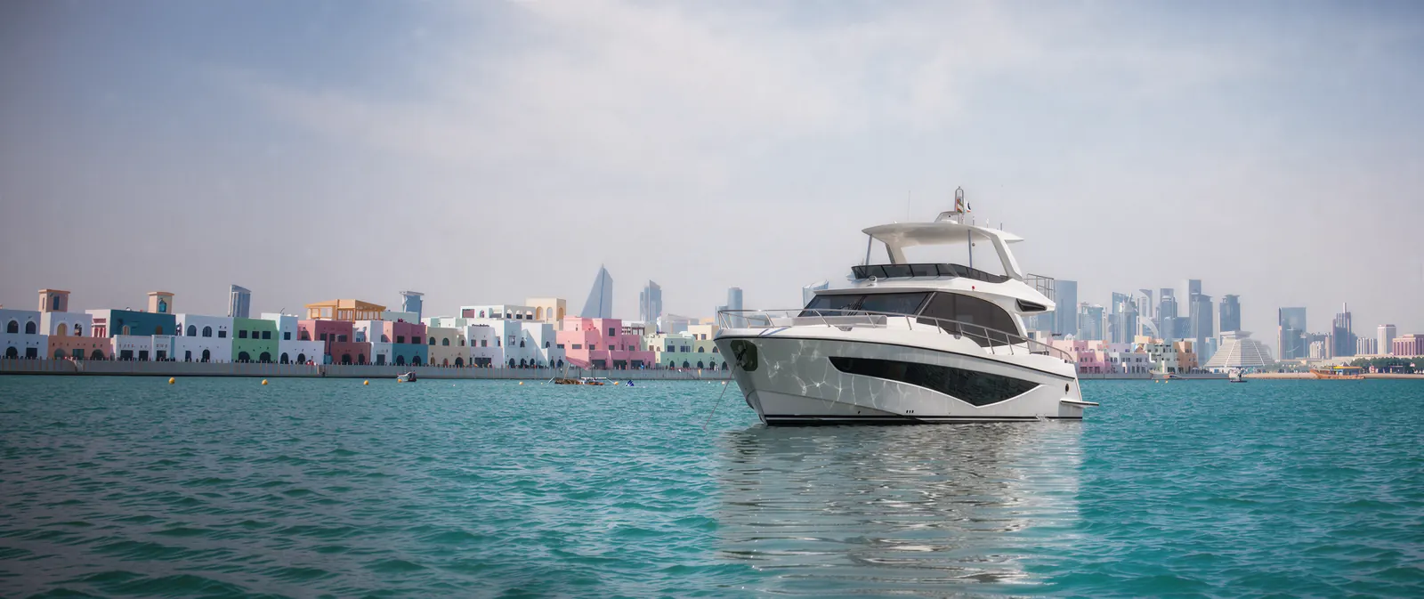 Majesty 65 at anchor off Doha with the West Bay skyline behind