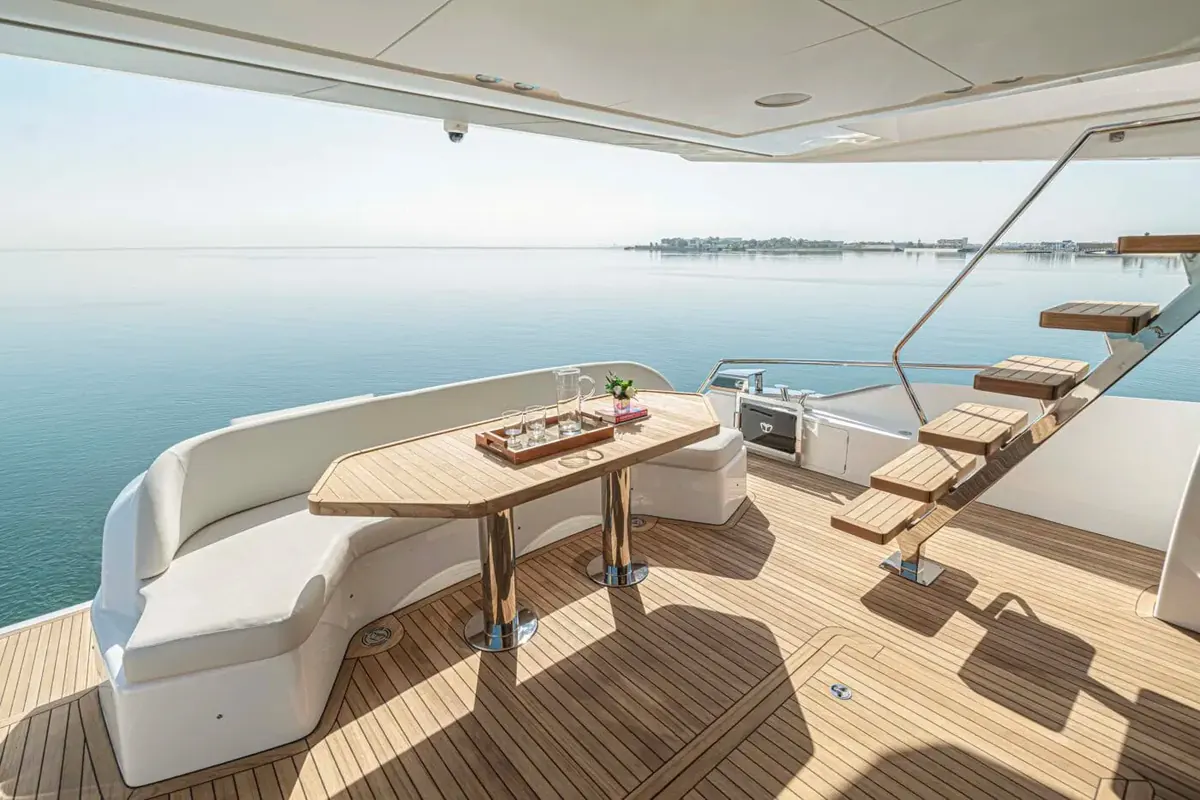 Majesty 60 aft cockpit with dining table and flybridge stairs