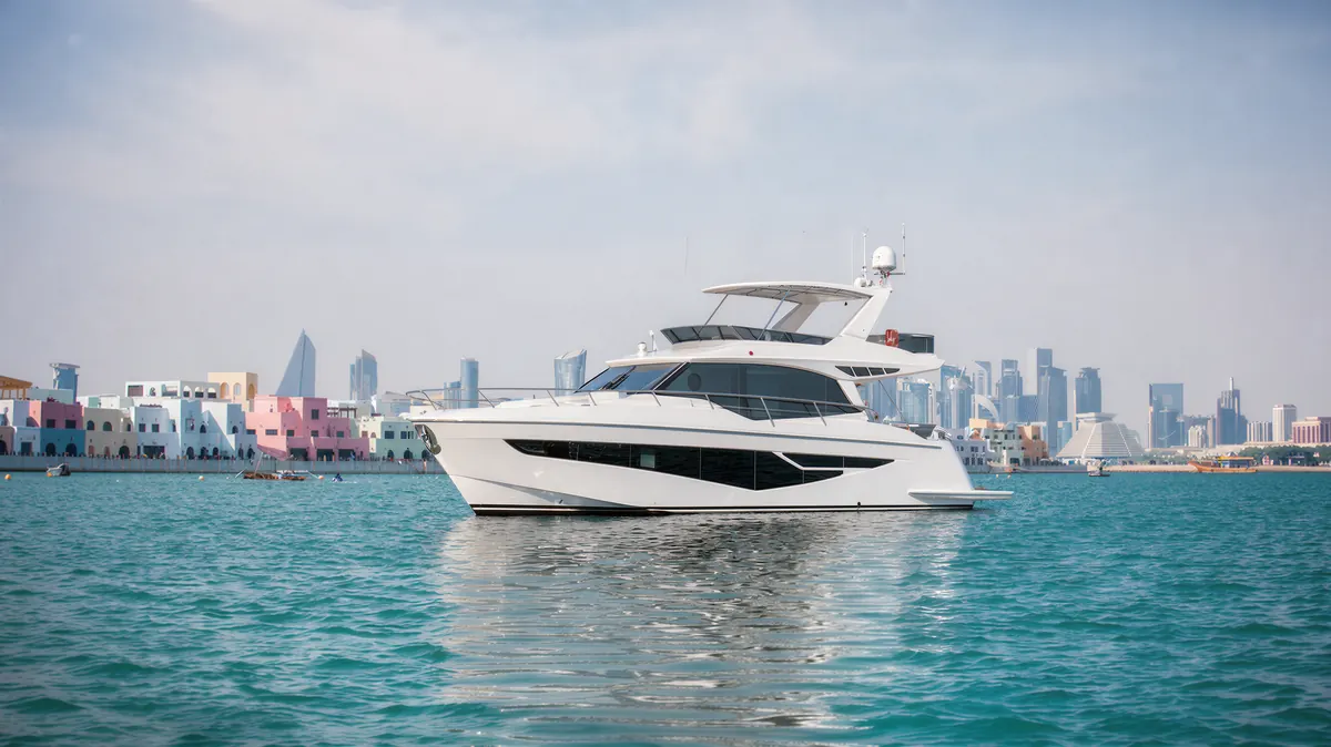 Majesty 60 at anchor off Old Doha Port, with the pastel Mina District and the Doha skyline behind