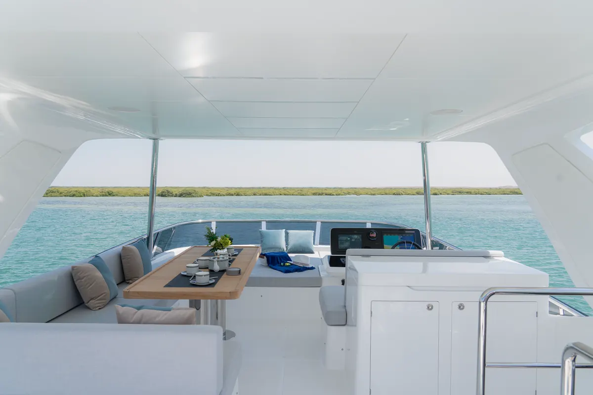 Majesty 65 flybridge with dining table and helm