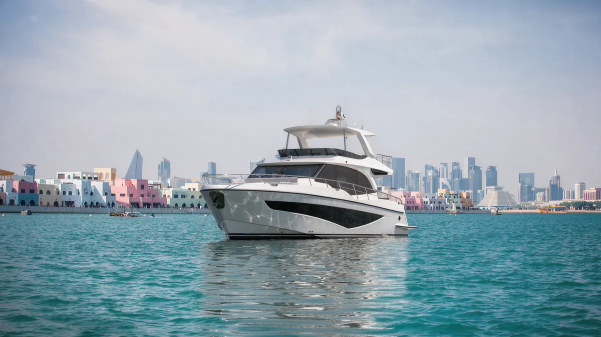 Majesty 65 at anchor off Old Doha Port with the West Bay skyline behind