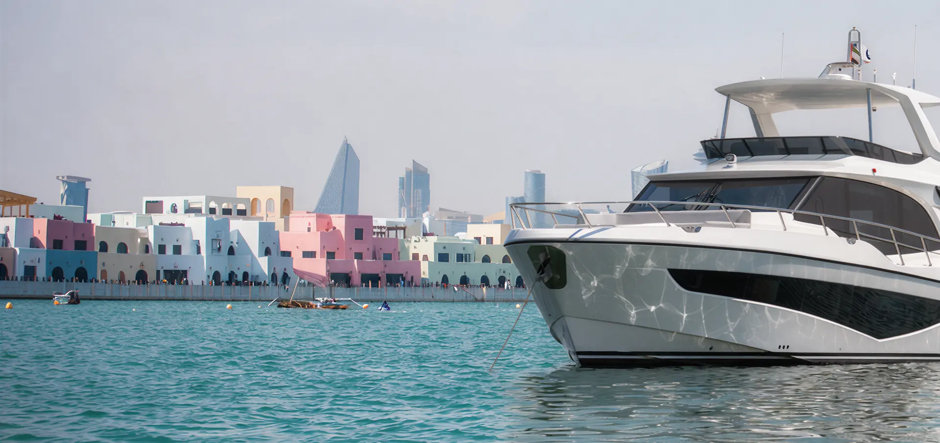 Majesty 65 moored at Old Doha Port, with the pastel waterfront of Mina District and the West Bay towers behind