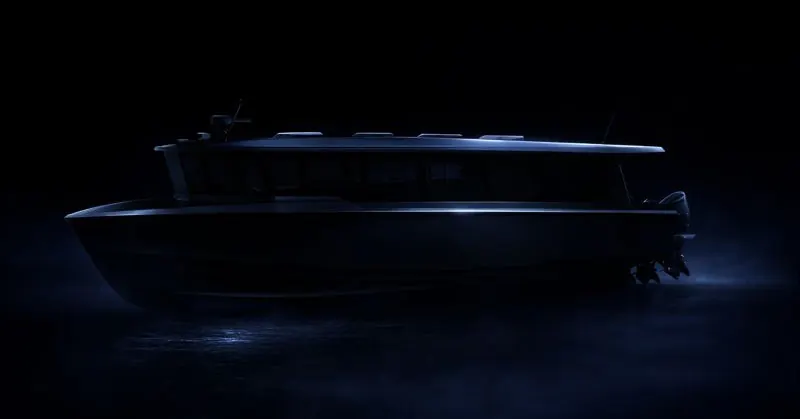 Touring 50 in silhouette against a dark background